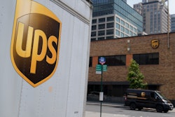 A delivery vehicle passes by a UPS depot in New York, June 29, 2023.