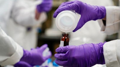 Water researcher Eva Stebel pours a sample at the EPA Center for Environmental Solutions and Emergency Response, Cincinnati, Feb. 16, 2023.