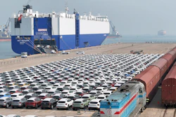 A freight train carrying cars to be exported arrives at a dock for ro-ro shipping in Yantai in eastern China's Shandong province Sunday, March 3, 2024.