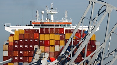 People are seen aboard the container ship Dali, Monday, April 15, 2024, in Baltimore.