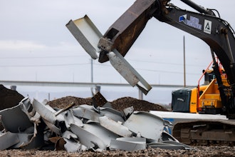 A machine splits a piece recovered from the collapsed Francis Scott Key Bridge at Tradepoint Atlantic on April 12, 2024, in Sparrows Point, Maryland.