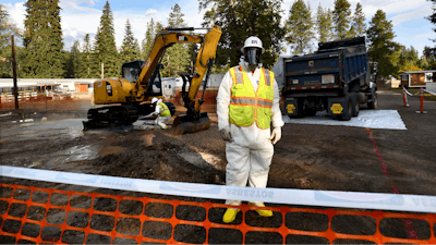 Environmental cleanup specialists work at one of the last remaining residential asbestos cleanup sites in Libby, Montana, in mid-September.