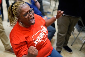 Volkswagen automobile plant employee Vicky Holloway celebrates as she watches the results of a UAW union vote, late Friday, April 19, 2024, in Chattanooga, Tenn.