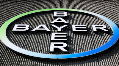 The Bayer AG corporate logo is displayed on a building of the German drug and chemicals company in Berlin, Monday, May 23, 2016.