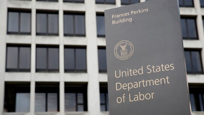 A sign stands outside the U.S. Department of Labor's headquarters, May 6, 2020, in Washington.
