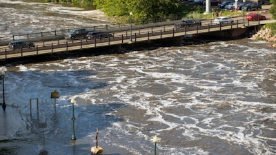 Water flows dangerously under the Falls Park Drive bridge at Falls Park, Sioux Falls, S.D., June 22, 2024.