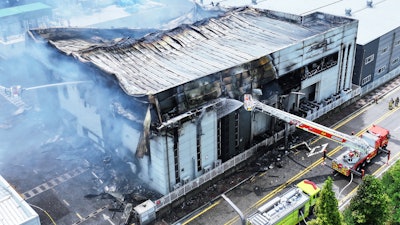 Firefighters work at the site of a burnt lithium battery manufacturing factory in Hwaseong, South Korea, Monday, June 24, 2024.