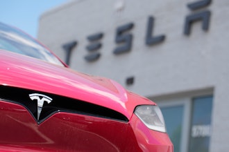 A Model X sports-utility vehicle sits outside a Tesla store in Littleton, Colo., June 18, 2023.