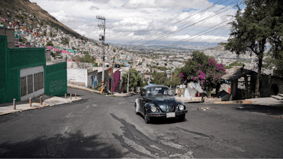Janette Navarro drives her 1996 Volkswagen Beetle up a steep hill in the Cuautepec neighborhood of Mexico City, Friday, June 21, 2024.