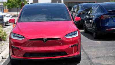 Unsold 2023 Model X sports-utility vehicles sit at a Tesla dealership, June 18, 2023, in Littleton, Colo.