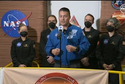 NASA Deputy Director of Flight Missions Kjell Lindgren speaks in front of the crew members of the first CHAPEA mission.