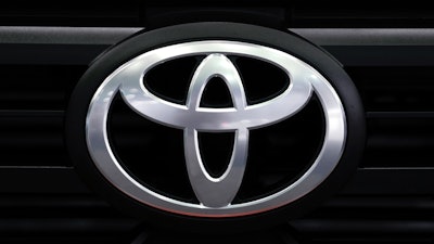 A Toyota logo is shown at the North American International Auto Show.