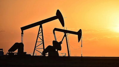 Pump jacks extract oil from beneath the ground in North Dakota, May 19, 2021.