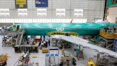 A Boeing 737 MAX aircraft is shown on the assembly line during a brief media tour at the Boeing facility in Renton, Wash., Tuesday, June 25, 2024.