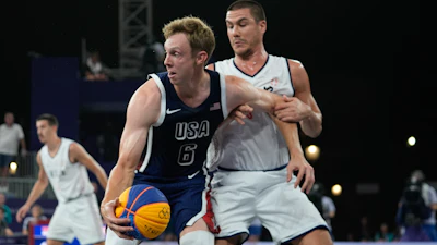 Canyon Barry of the United States fends off Mihailo Vasic of Serbia in the men's 3x3 basketball pool round match between Serbia and the United States at the 2024 Summer Olympics, Tuesday, July 30, 2024, in Paris, France.