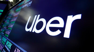 The Uber logo appears above a trading post on the floor of the New York Stock Exchange.