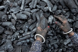 A woman works at a coal depot in Ahmedabad, India.