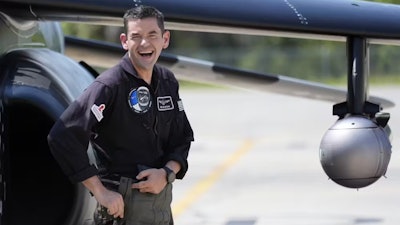 Jared Isaacman, founder and CEO of Shift4 and the commander of Polaris Dawn, stands in front of a plane.