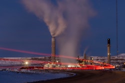 Taillights trace the path of a motor vehicle at the Naughton Power Plant, Jan. 13, 2022, in Kemmerer, Wyo., next to a site where Bill Gates and his energy company are starting construction on a next-generation nuclear plant.