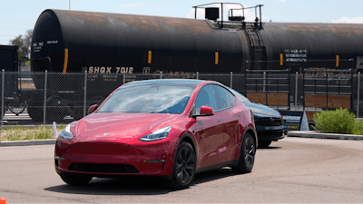 Drivers guide 2024 a Tesla Model 3 sedan and Model X utility vehicle, rear, along a test track at the Electrify Expo in The Yards on July 14, 2024, in north Denver.