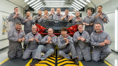 In this photo provided by Nissan on Thursday, Sept. 5, 2024, workers of Nissan's plant’s Paint Shop including John Johnson, foreground right and Michael Connolly, foreground, second left, pose for a photo at the plant, in Sunderland, England.