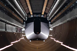 A test vehicle levitated by magnetic fields zips through a depressurized tube in a testing ground for a high-speed transit system during a press tour of a European test center for hyperloop transportation technology in Veendam, northern Netherlands.