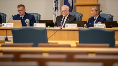 Members of the Coast Guard's Titan Submersible Marine Board of Investigation listen during the formal hearing inside the Charleston County Council Chambers, Monday, Sept. 23, 2024, in North Charleston, S.C.