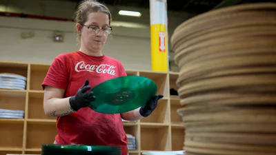 Tannika Benjamin inspects a vinyl record at the United Record Pressing plant July 11, 2024, in Nashville, Tenn.