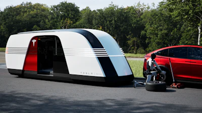In this rendering, a Tesla Bot arrives via Robovan to repair a Tesla car.