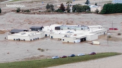 In this image made from a video provided by NewsNation, people can be seen on the roof of the Unicoi County Hospital in Erwin, Tenn., on Friday, Sept. 27, 2024.