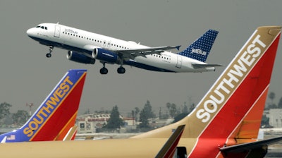 A JetBlue Airbus flies over a pair of Southwest Airlines' jets from Bob Hope Airport in Burbank, Calif., bound for New York's JFK airport, July 19, 2005.
