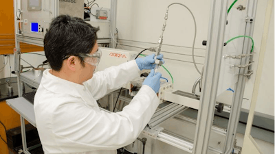 WVU researcher Yuxin Wang loads polypropylene into a microwave reactor. Wang is leading a study that explores the use of microwave technology in plastic upcycling.