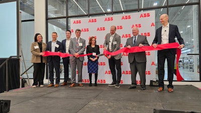 ABB Motion President Brandon Spencer cuts the ribbon at the company's new campus in New Berlin, Wisconsin.