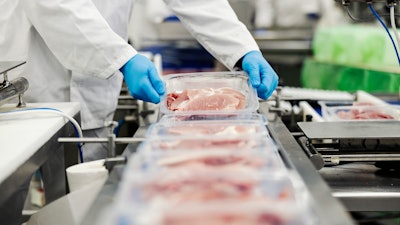 Meat placed on a line in a meat production plant.