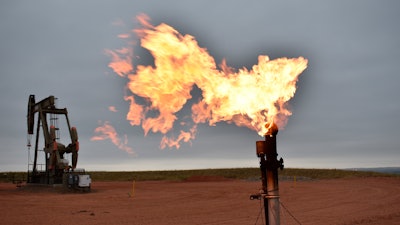 A flare burns natural gas at an oil well in Watford City, N.D., Aug. 26, 2021.