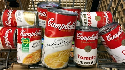 This May 23, 2017, file photo shows a variety of Campbell's soups in a grocery cart at a store in Phoenix.