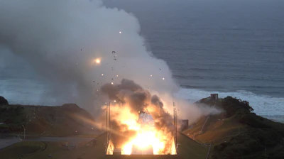In this photo provided by Japan Aerospace Exploration Agency (JAXA), smoke and fire are seen during a combustion test of an engine for new small Japanese rocket Epsilon S at Tanegashima Space Center, Kagoshima prefecture, southern Japan, Tuesday, Nov. 26, 2024.