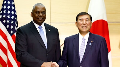 U.S. Defense Secretary Lloyd Austin, left, shakes hands with Japan's Prime Minister Shigeru Ishiba at the start of their bilateral meeting at the prime minister's official residence in Tokyo, Japan, Dec. 10, 2024.