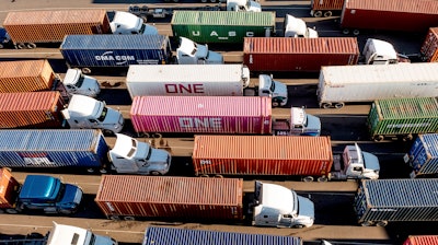 Trucks line up to enter a Port of Oakland shipping terminal in Oakland, Calif., Nov. 10, 2021.