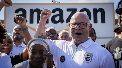 Teamsters General President Sean M. O'Brien, center, rallies with Amazon workers outside the Staten Island Amazon facility JFK8, June 19, 2024, New York.