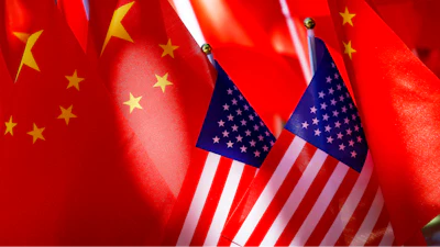 American flags are displayed with Chinese flags on top of a trishaw on Sept. 16, 2018, in Beijing.