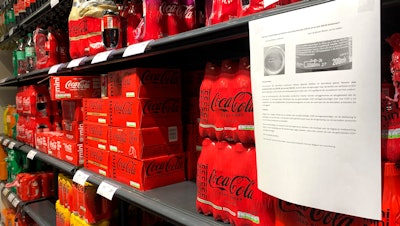 A note is posted next to cleared cases of soft drinks in a supermarket, Antwerp, Belgium, Jan. 28, 2025.