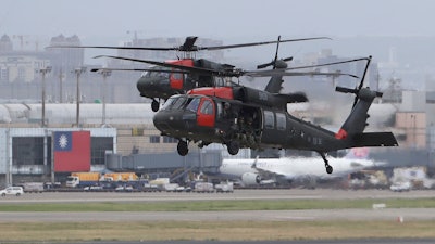 Two Sikorsky UH-60 'Black Hawk' helicopters approach during the annual Han Kuang military exercises that simulates an attack on an airfield at Taoyuan International Airport in Taoyuan, northern Taiwan, Wednesday, July 26, 2023.