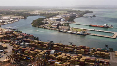 Cargo containers sit stacked as cranes load and unload containers from cargo ships at the Cristobal port, operated by the Panama Ports Company, in Colon, Tuesday, Panama, Feb. 4, 2025.