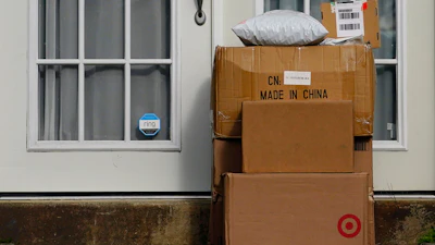 Packages are seen stacked on the doorstep of a residence, Wednesday, Oct. 27, 2021, in Upper Darby, Pa.