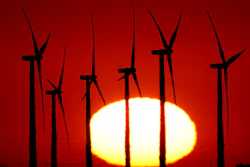 Wind turbines at the Buckeye Wind Energy are diffused by heat vapors as the are silhouetted against the rising sun, Sept. 30, 2024, near Hays, Kan.