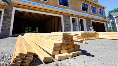 Lumber is piled at a housing construction site, June 24, 2021, Middleton, Mass.