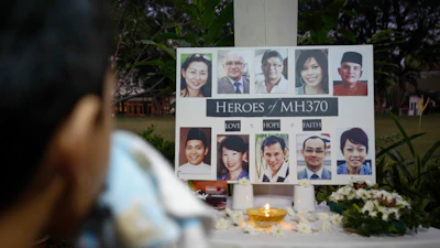 A Malaysian boy wipes his tears during a special prayer for the ill fated Malaysia Airlines Flight 370 at a church in Kuala Lumpur, Malaysia, Tuesday, March 8, 2016.