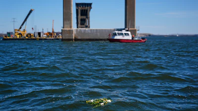 A wreath laid by family members of the victims who died during the collapse of the Francis Scott Key Bridge in Baltimore float in the Chesapeake Bay, March 25, 2025.