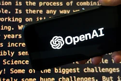 The OpenAI logo appears on a mobile phone in front of a screen showing part of the company website in this photo taken on Nov. 21, 2023 in New York.